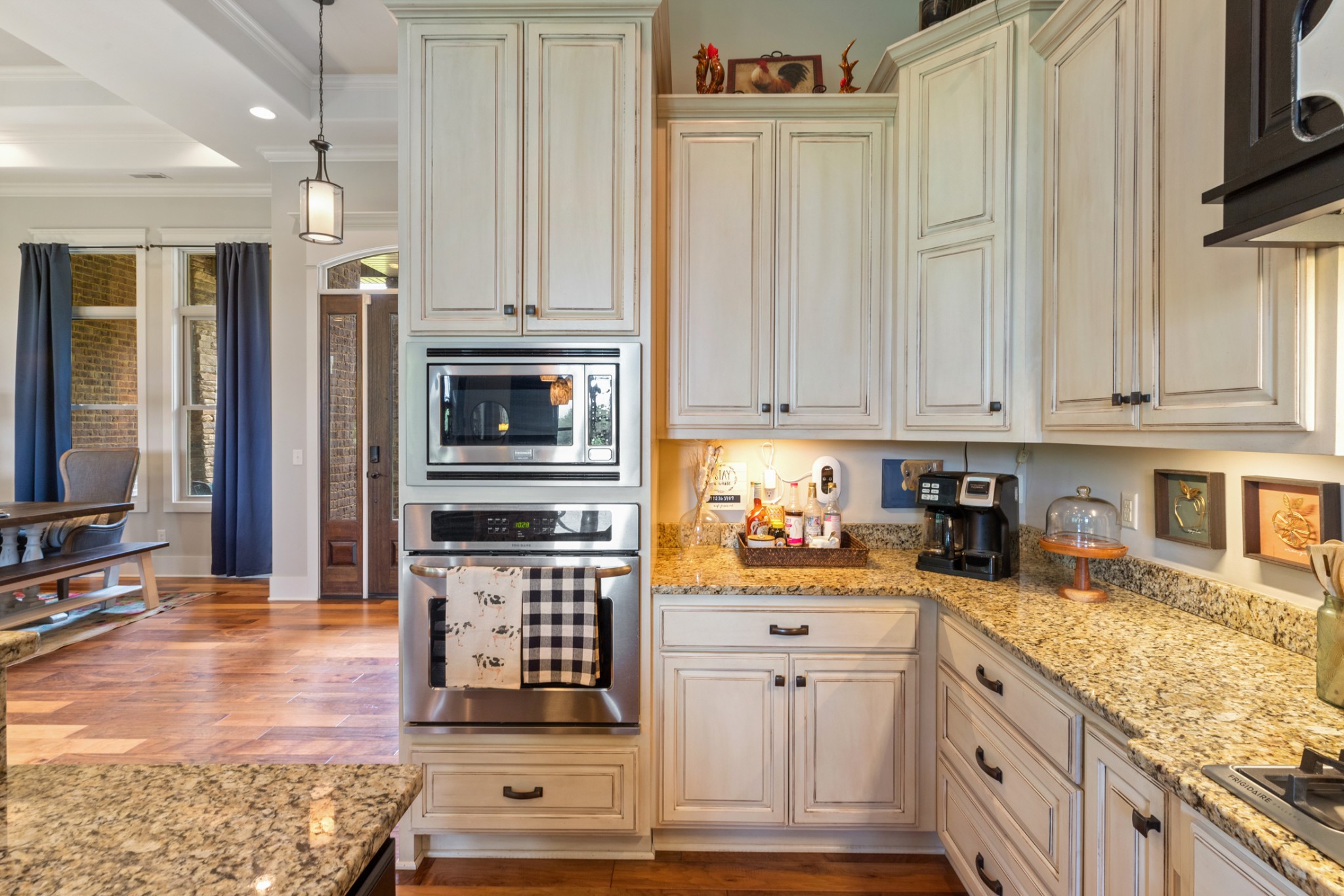 532 South Tidwell Road Bon Aqua, TN 37025 - Photo 32 of 100 a kitchen with stainless steel appliances granite countertop a stove top oven a sink dishwasher and a microwave oven with white cabinets