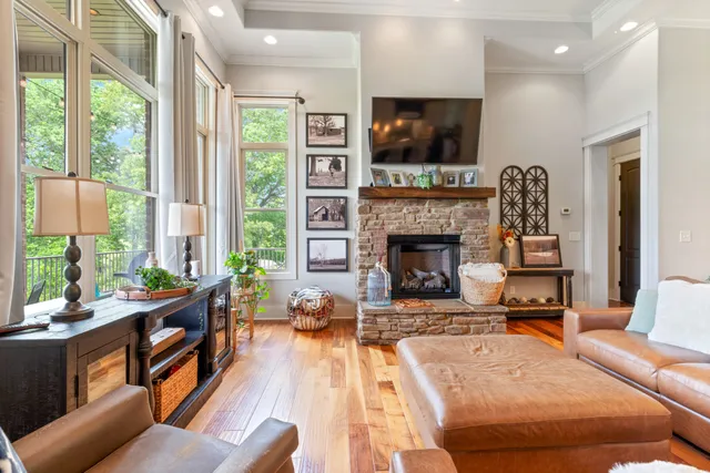a living room with furniture a ceiling fan and a rug