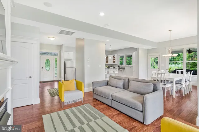 a kitchen with white cabinets and sink