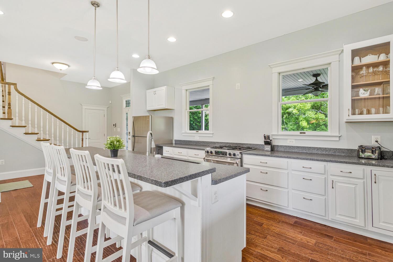 50333 Scotland Beach Road Scotland, MD 20687 - Photo 15 of 80 a kitchen with white cabinets and sink