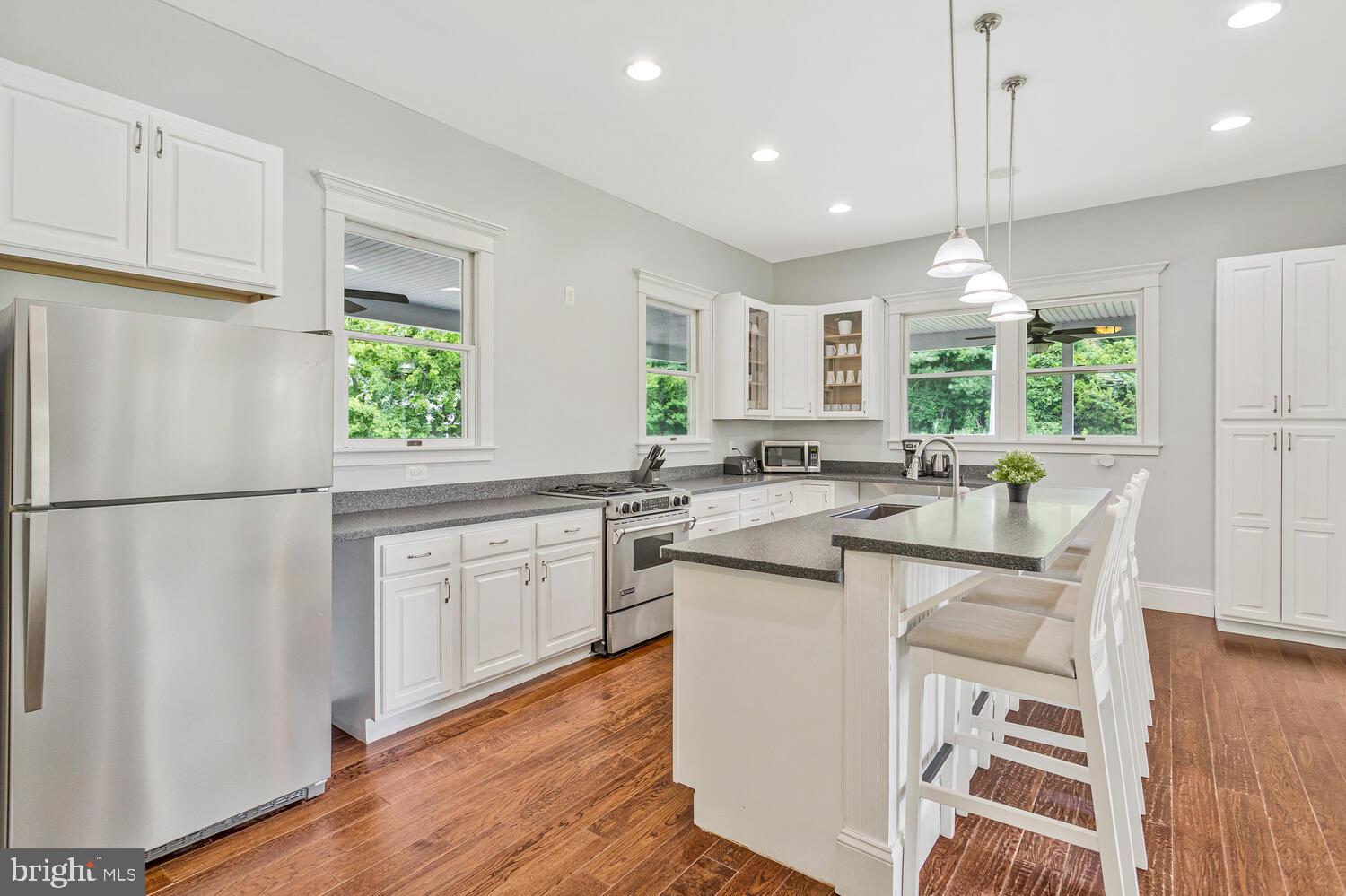 50333 Scotland Beach Road Scotland, MD 20687 - Photo 18 of 80 a kitchen with white cabinets and white appliances