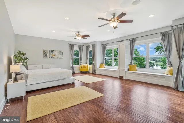 a spacious bedroom with a bed and a window