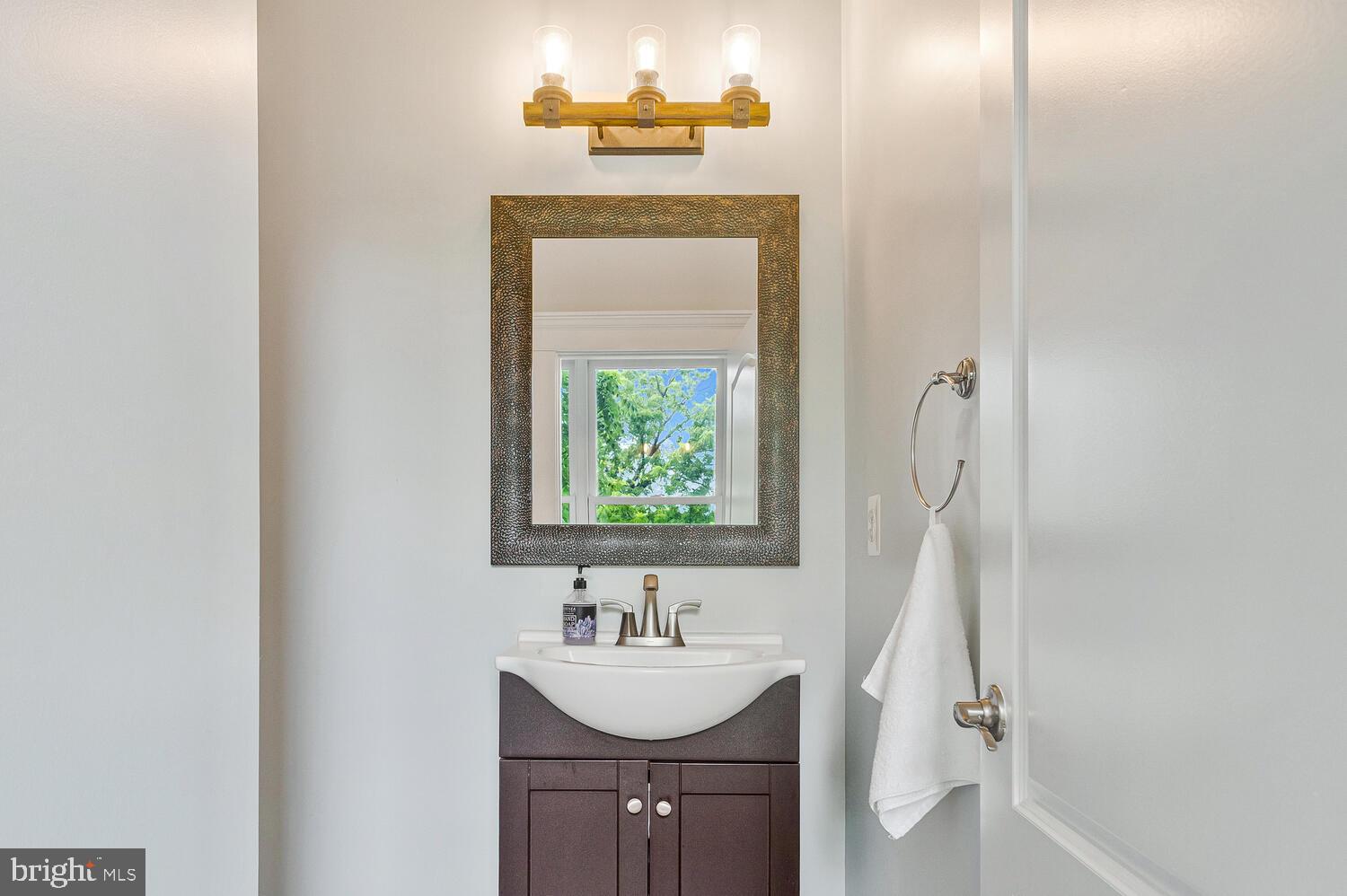 50333 Scotland Beach Road Scotland, MD 20687 - Photo 23 of 80 a bathroom with a sink a mirror and a window