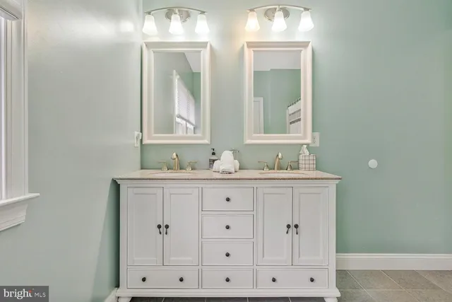 a living room with furniture a table and kitchen view