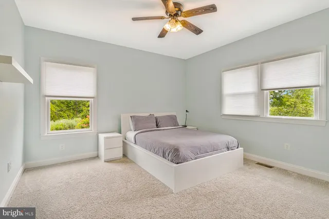 a bedroom with a large bed and a large window