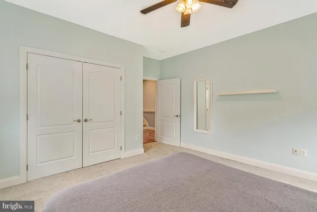 a bathroom with a sink a toilet a mirror and shower