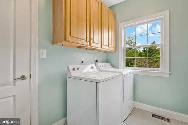 an aerial view of a house with garden space and outdoor seating