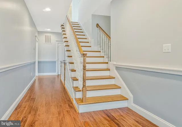 a view of a house with a big yard and large trees