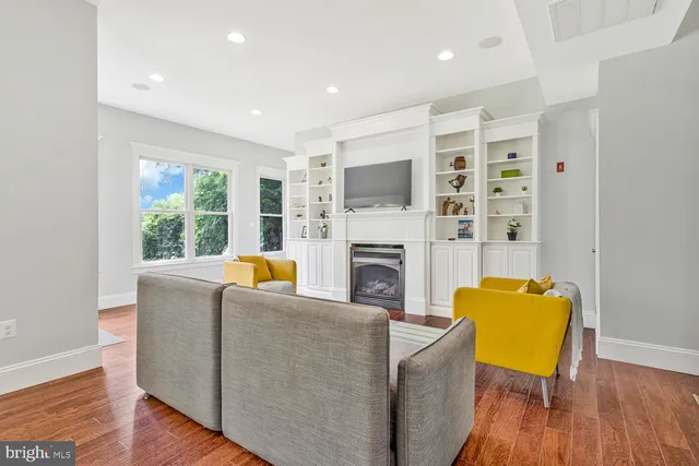 a dining room with wooden floor a chandelier a glass table and chairs