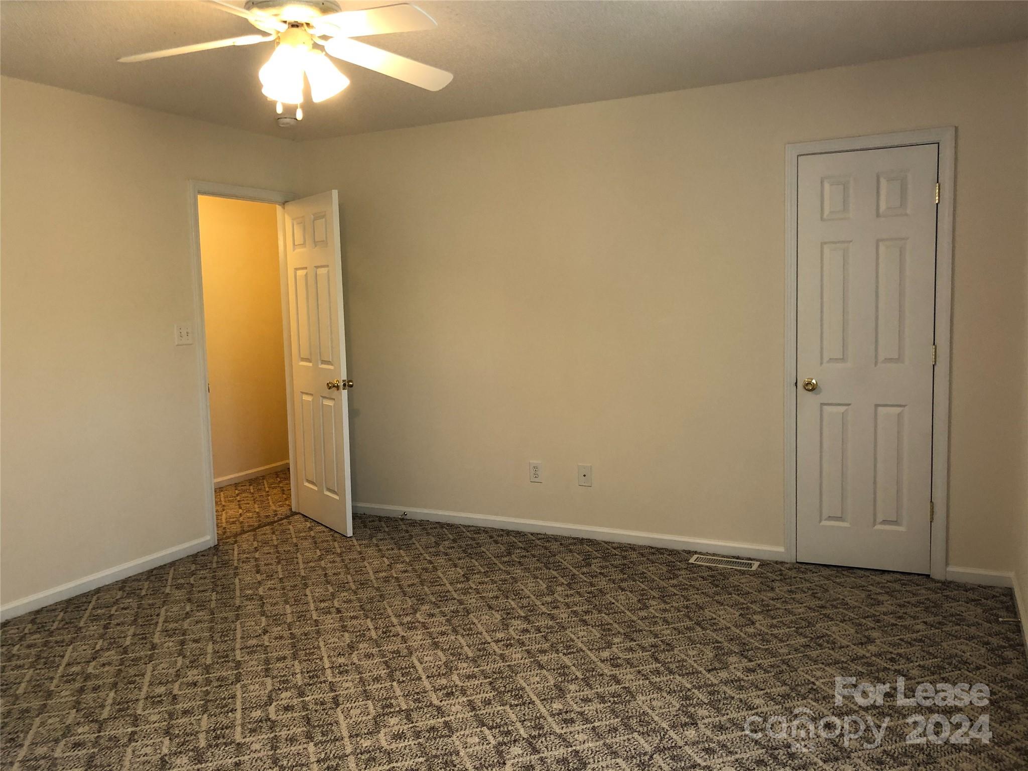 6381 Kidville Road Denver, NC 28037 - Photo 12 of 19 an empty room with a chandelier fan