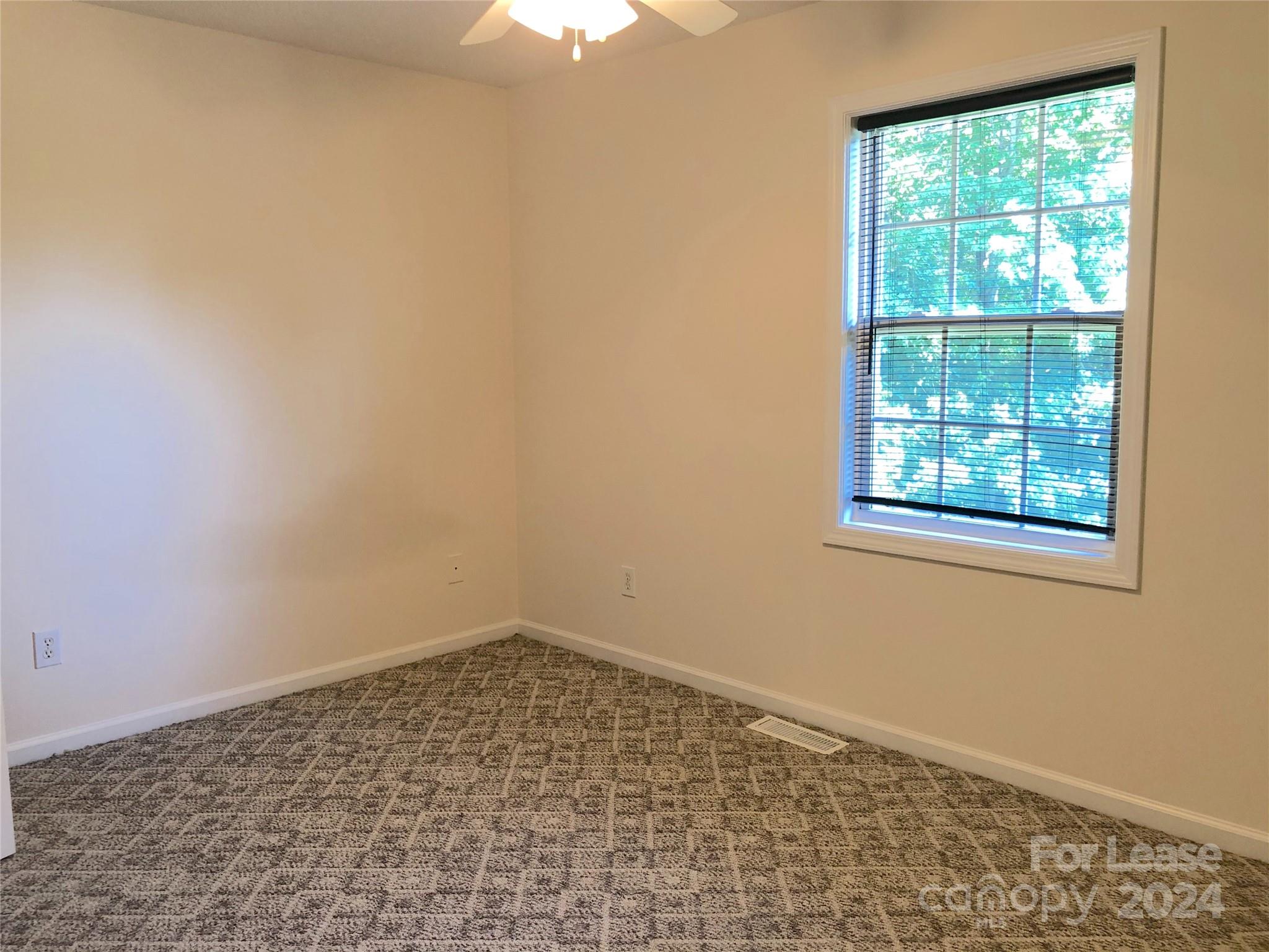 6381 Kidville Road Denver, NC 28037 - Photo 18 of 19 an empty room with a window