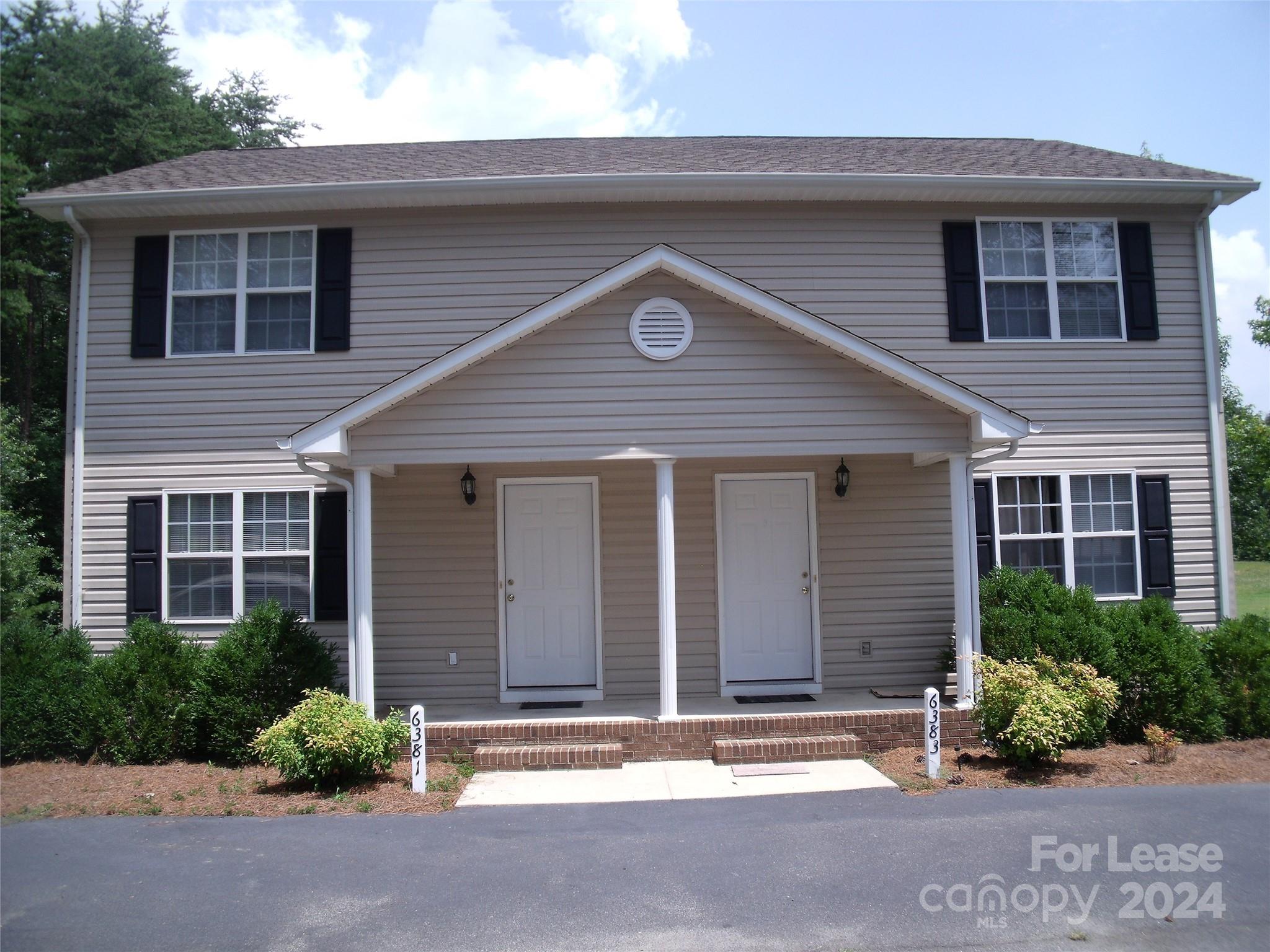6381 Kidville Road Denver, NC 28037 - Photo 2 of 19 a front view of a house with a yard and garage