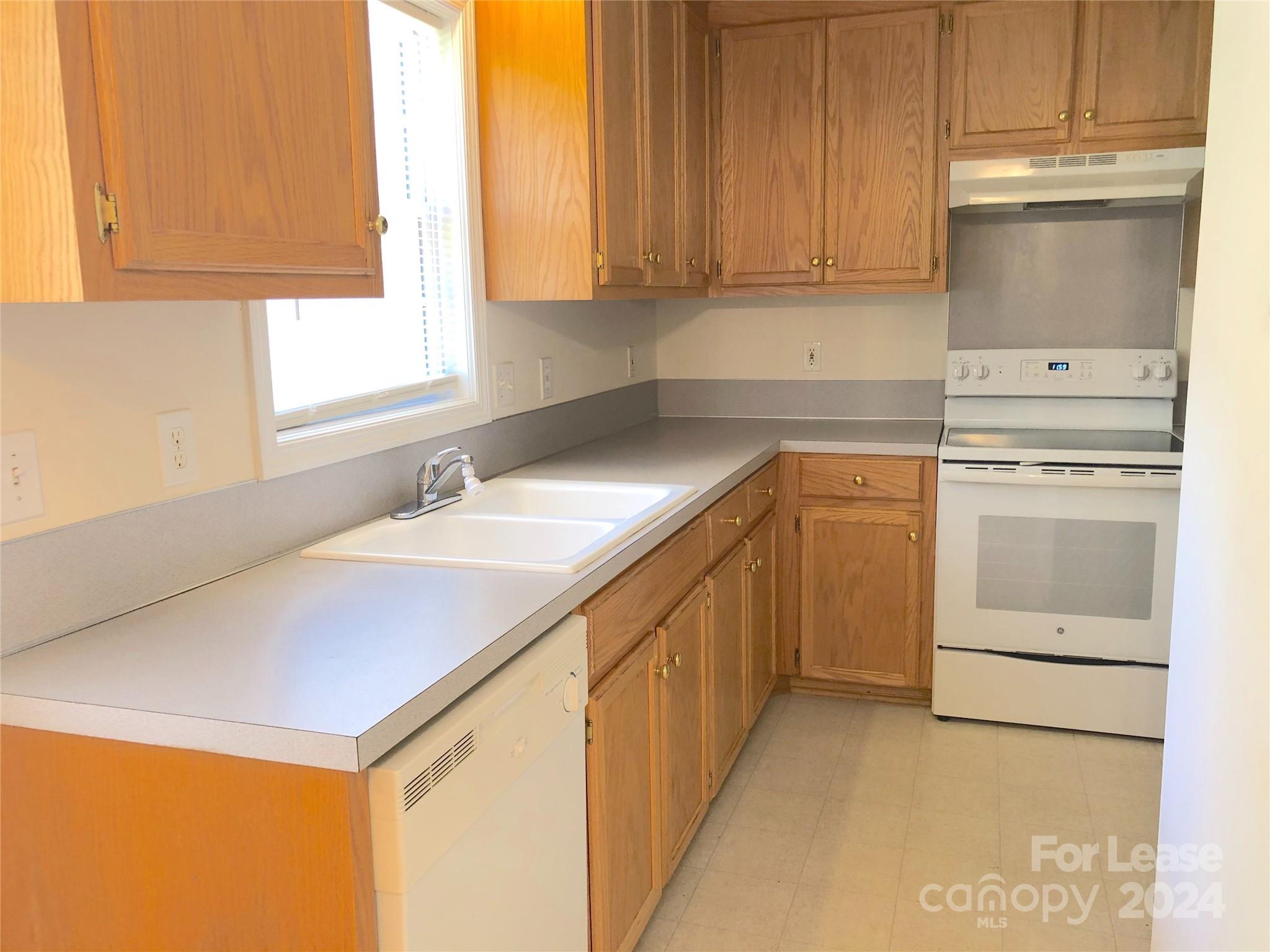 6381 Kidville Road Denver, NC 28037 - Photo 3 of 19 a kitchen with a sink and cabinets