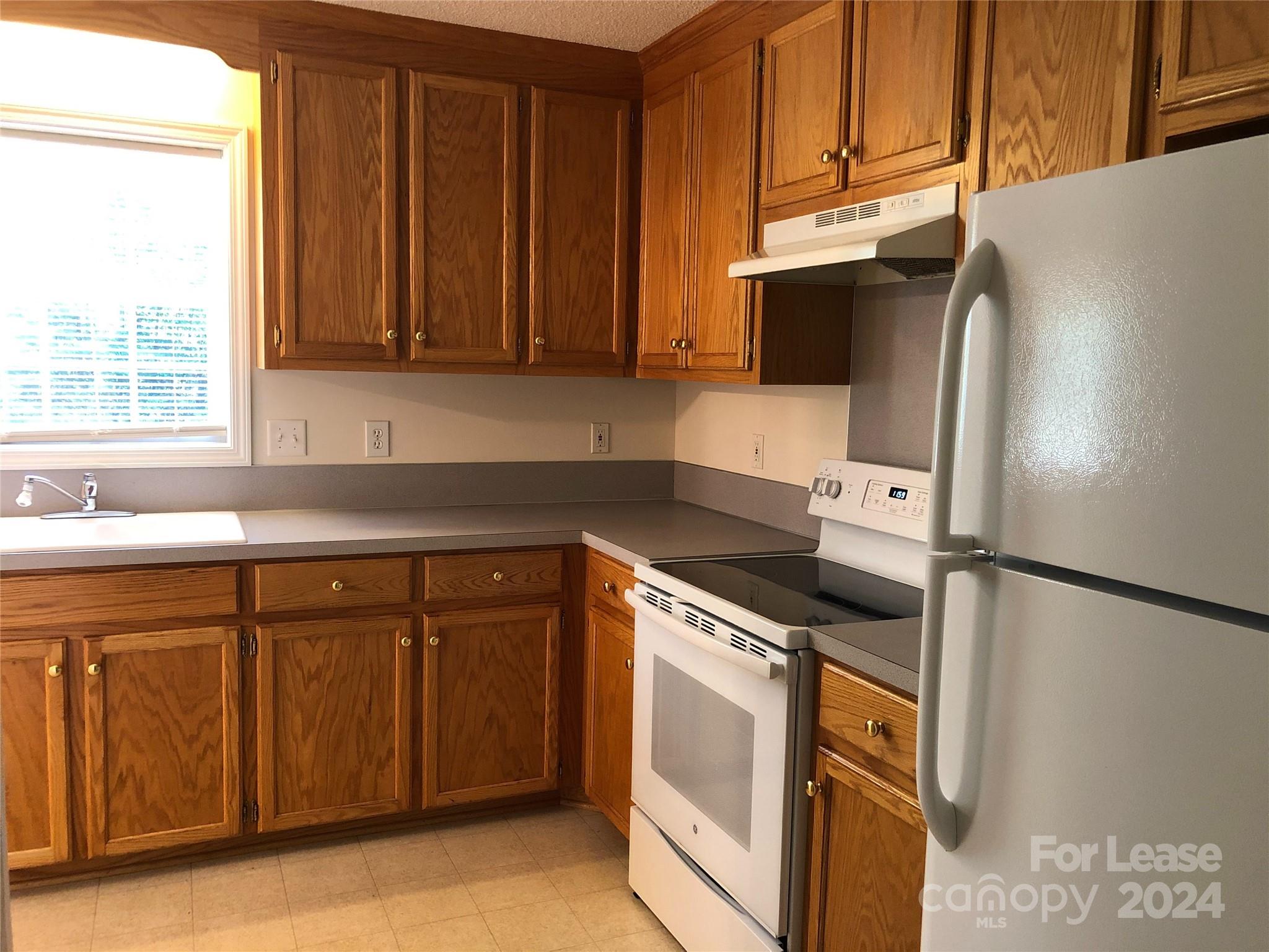 6381 Kidville Road Denver, NC 28037 - Photo 4 of 19 a kitchen with stainless steel appliances granite countertop a refrigerator and a sink