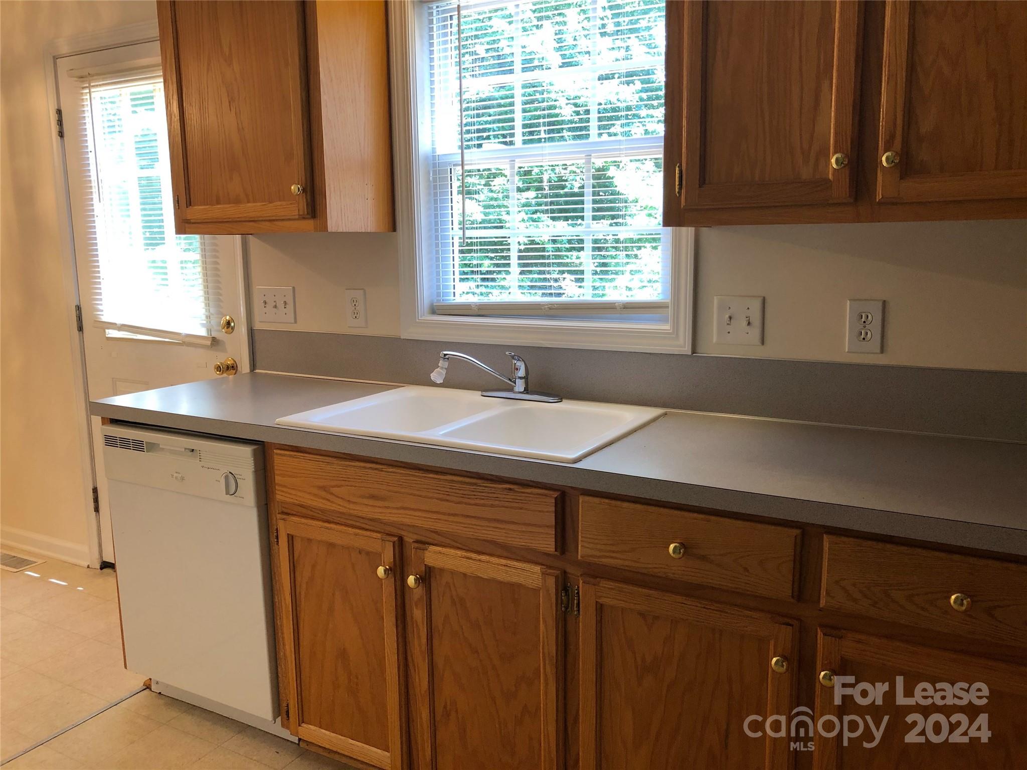 6381 Kidville Road Denver, NC 28037 - Photo 5 of 19 a kitchen with a sink and cabinets