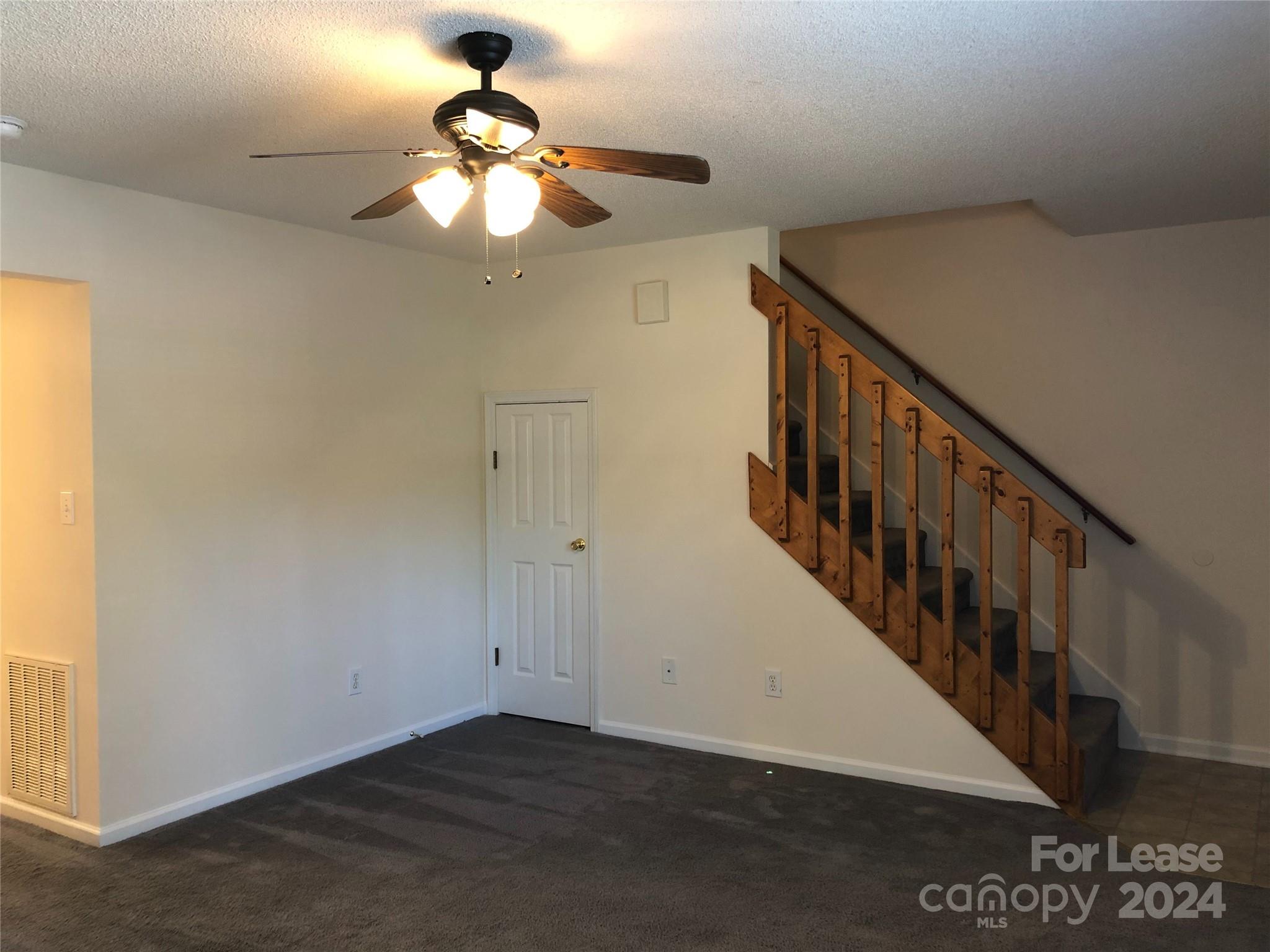 6381 Kidville Road Denver, NC 28037 - Photo 7 of 19 a view of staircase with railing and chandelier