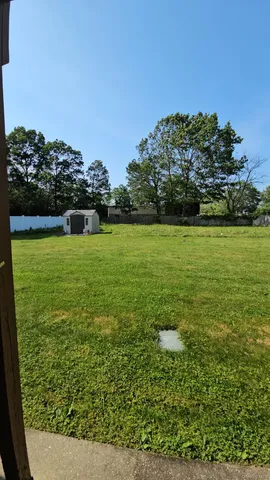 a view of a field with an ocean