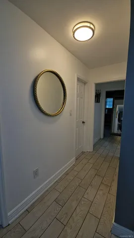 a view of a room with wooden floor and a window