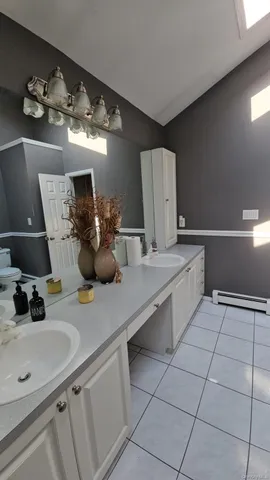 a bathroom with a sink a vanity and mirror