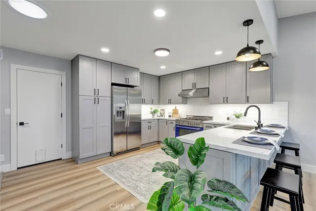 a kitchen with a table stainless steel appliances and cabinets
