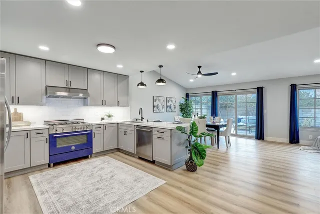 a open kitchen with lots of counter top space and stainless steel appliances