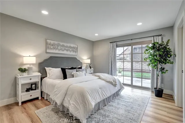 a bedroom with bed and a large window