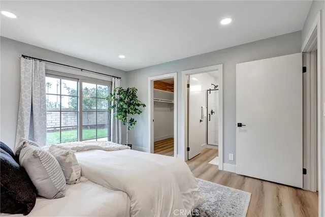 a bedroom with a large bed and a large window