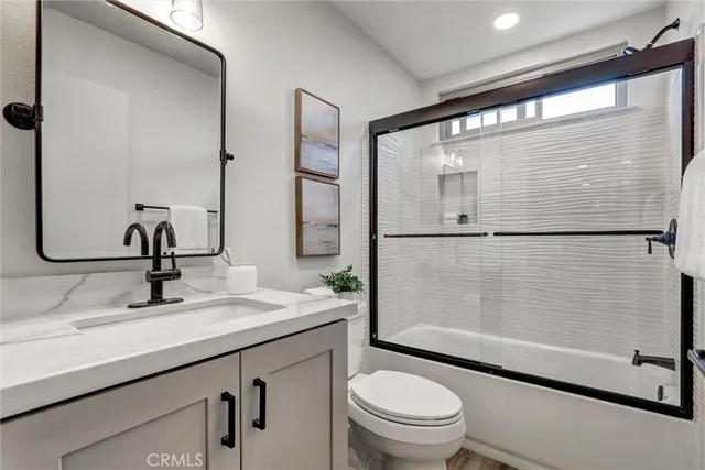 a bathroom with a sink shower and a mirror