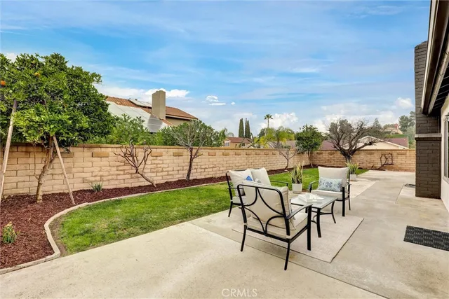 a view of a backyard with sitting area