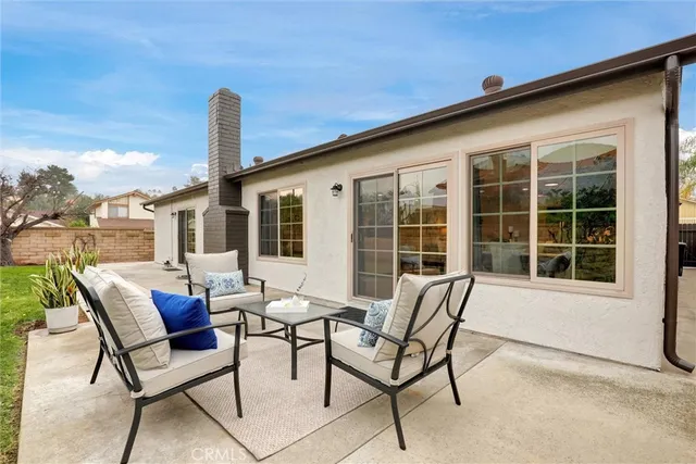 a view of a patio with a table and chairs