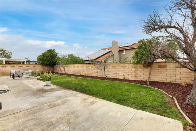 a view of a backyard with wooden fence