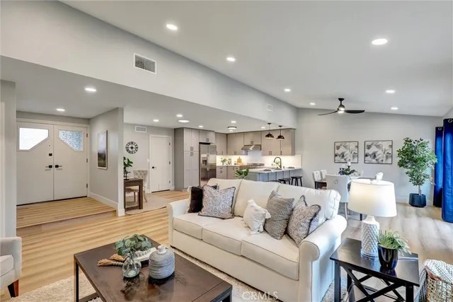 a living room with furniture kitchen view and a refrigerator