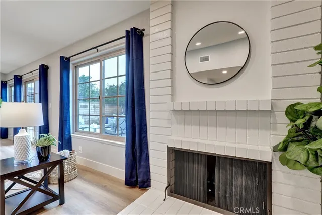 a front view of a house with wooden floor and a potted plant