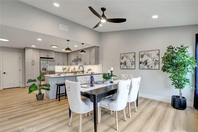 a dining room with furniture and potted plant