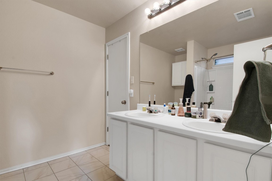 18205 Topsail Street Manor, TX 78653 - Photo 17 of 29 Full bath with double vanity and light tile patterned floors
