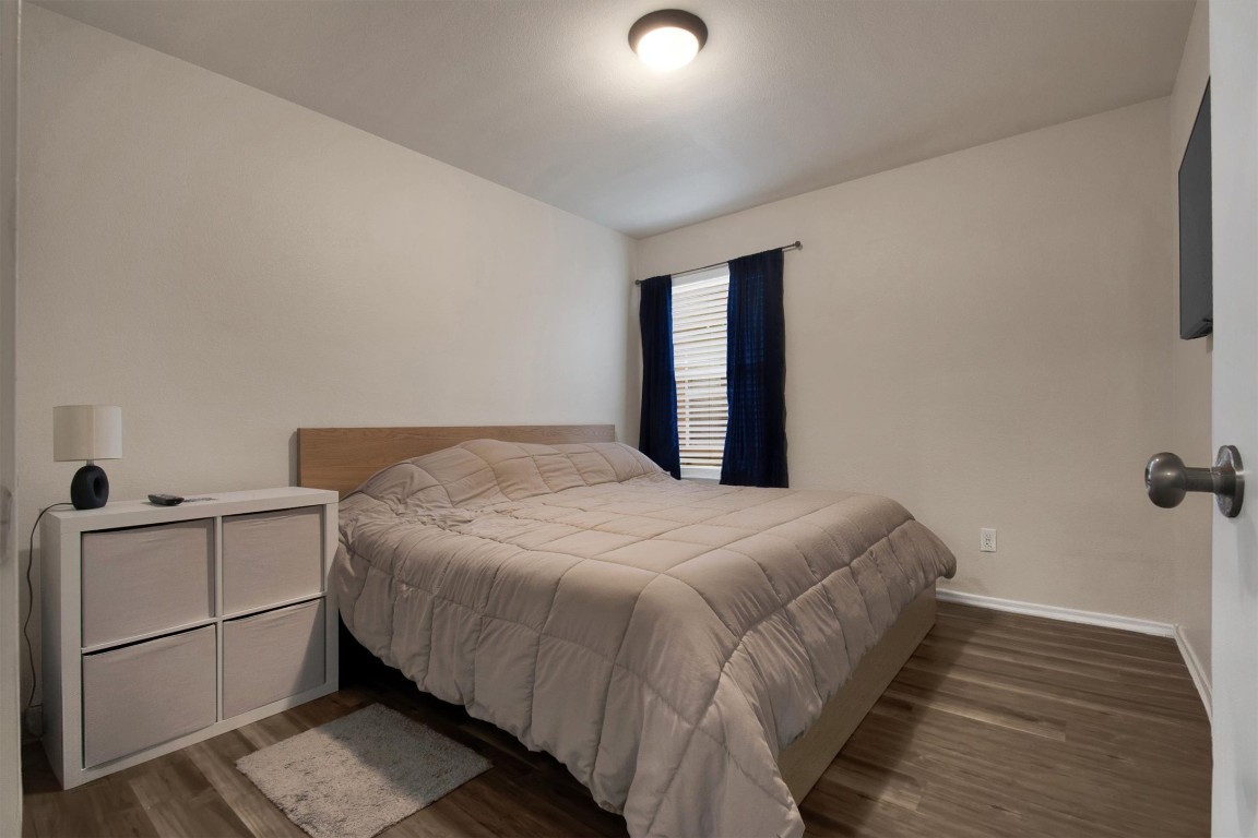 18205 Topsail Street Manor, TX 78653 - Photo 21 of 29 Bedroom featuring dark wood-type flooring