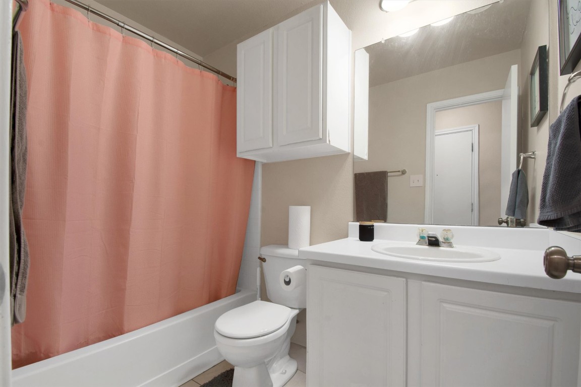 18205 Topsail Street Manor, TX 78653 - Photo 24 of 29 Full bath featuring vanity and shower / bathtub combination with curtain