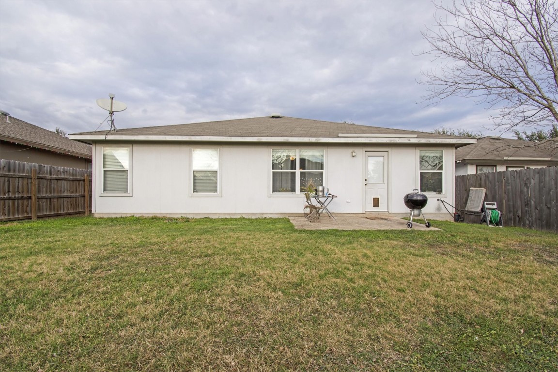 18205 Topsail Street Manor, TX 78653 - Photo 28 of 29 Back of house featuring a fenced backyard and a patio
