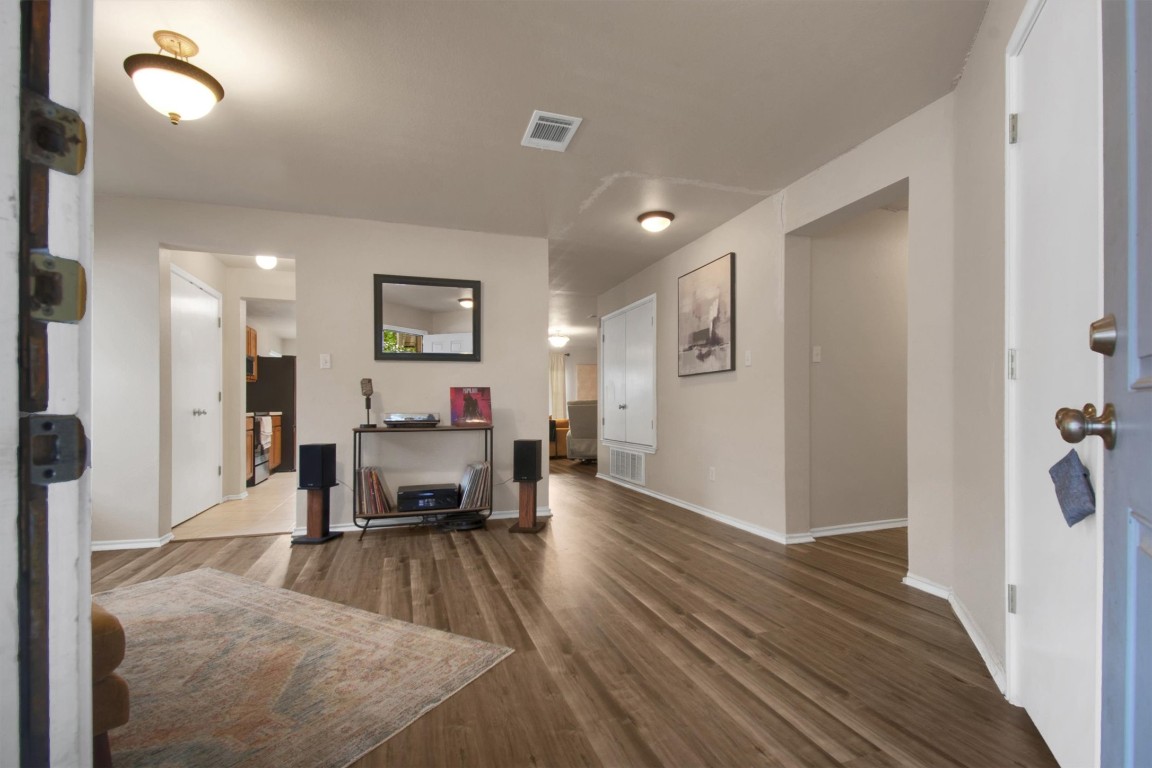 18205 Topsail Street Manor, TX 78653 - Photo 4 of 29 Entryway featuring dark wood-type flooring and baseboards