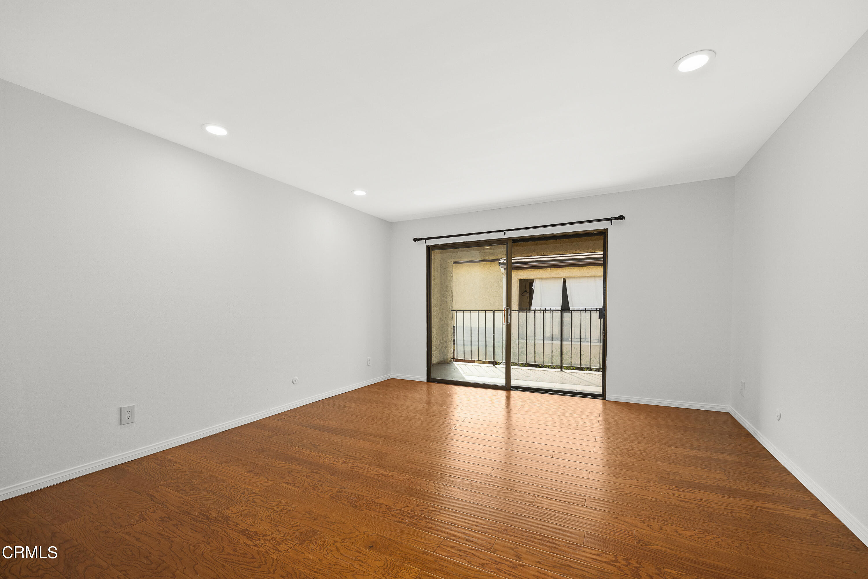 585 West Duarte Road, Unit 24A Arcadia, CA 91007 - Photo 11 of 23 a view of an empty room with wooden floor and windows