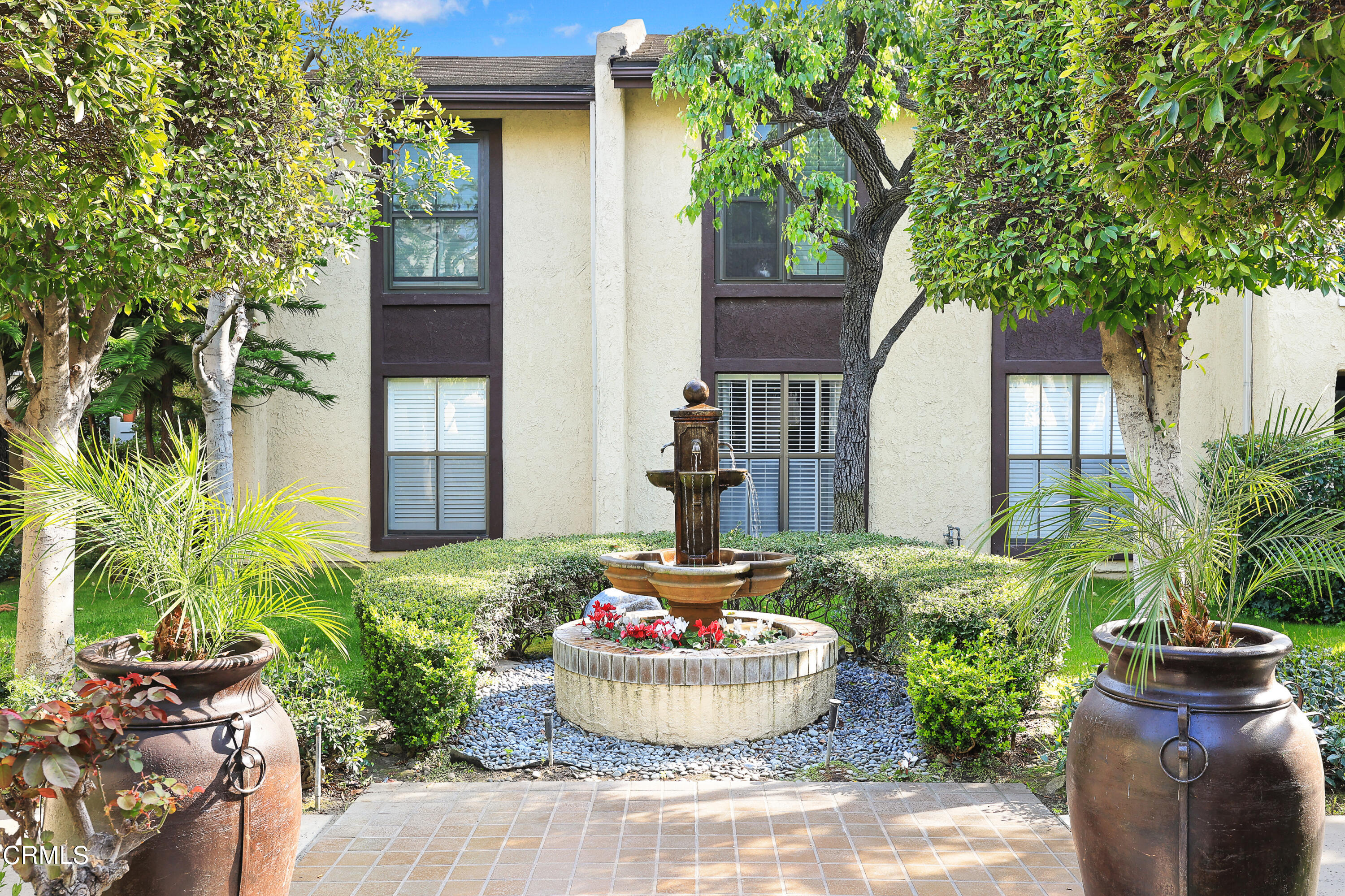 585 West Duarte Road, Unit 24A Arcadia, CA 91007 - Photo 17 of 23 a front view of a house with a chairs and a potted plant