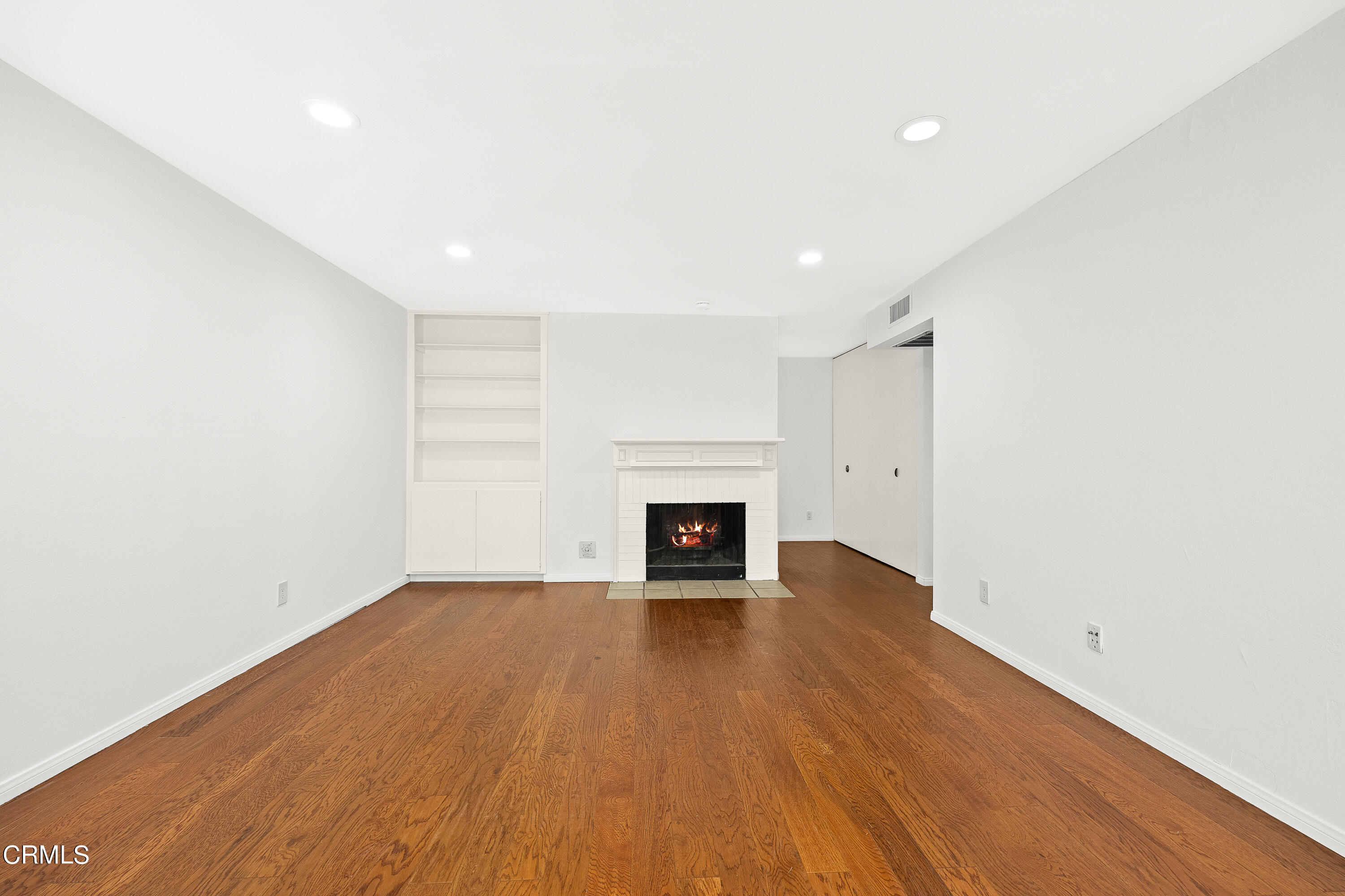 585 West Duarte Road, Unit 24A Arcadia, CA 91007 - Photo 4 of 23 an empty room with wooden floor and fireplace