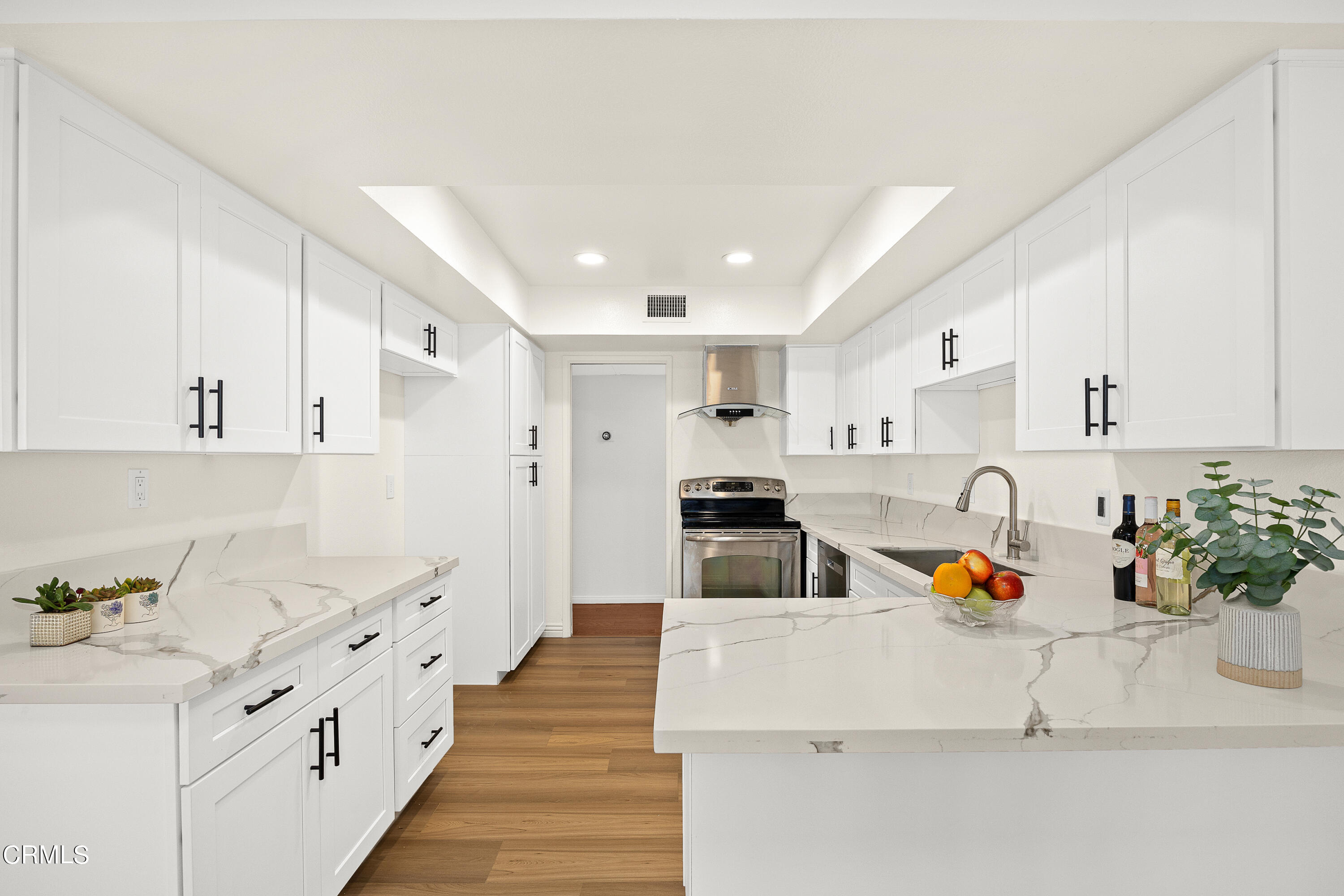 585 West Duarte Road, Unit 24A Arcadia, CA 91007 - Photo 9 of 23 a large white kitchen with stainless steel appliances lots of counter space and window