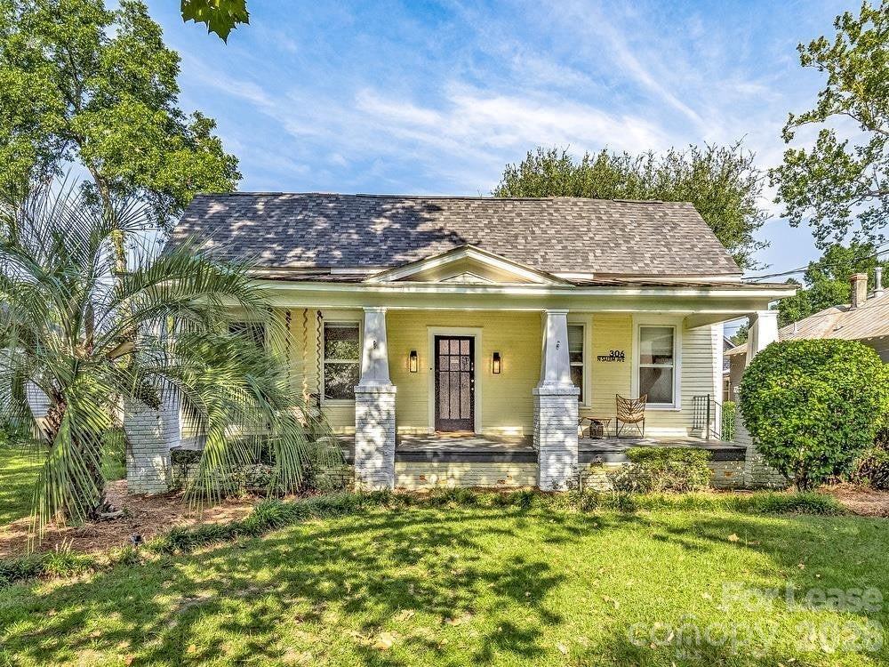 306 North Salem Avenue Sumter, SC 29150 - Photo 1 of 5 a front view of a house with a garden