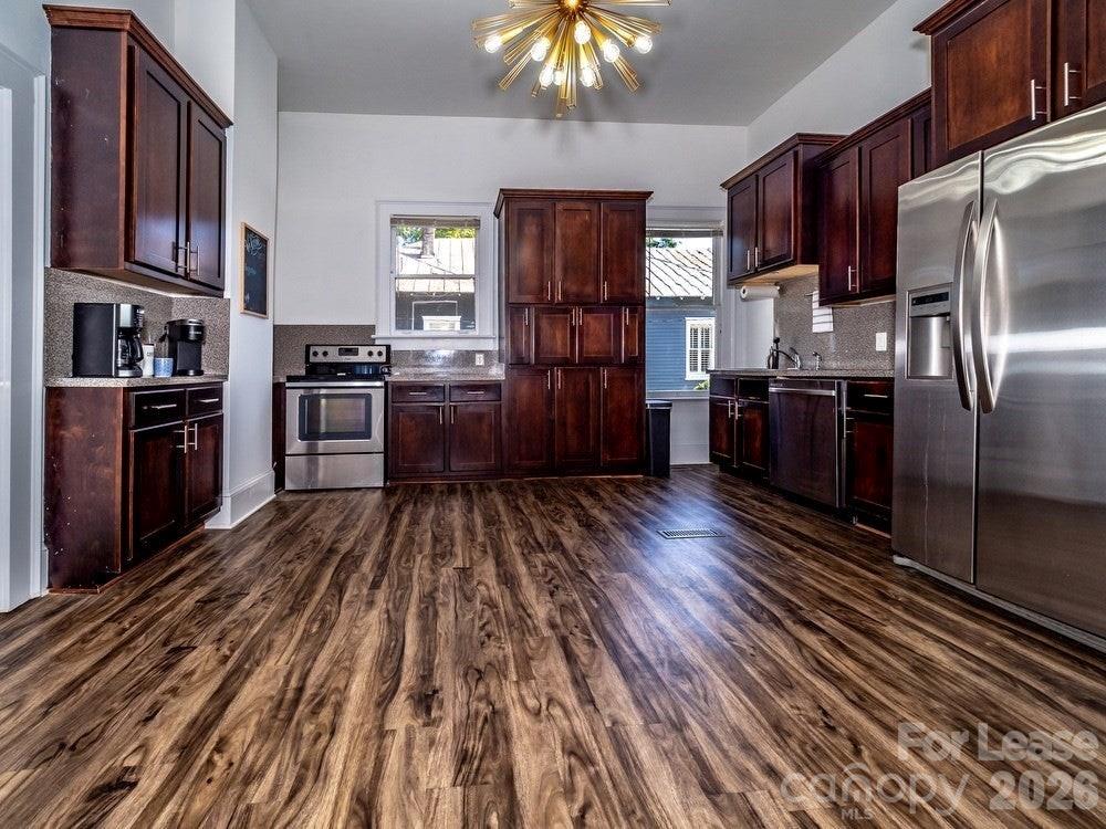 306 North Salem Avenue Sumter, SC 29150 - Photo 3 of 5 a kitchen with stainless steel appliances granite countertop a refrigerator oven a sink dishwasher and wooden floor