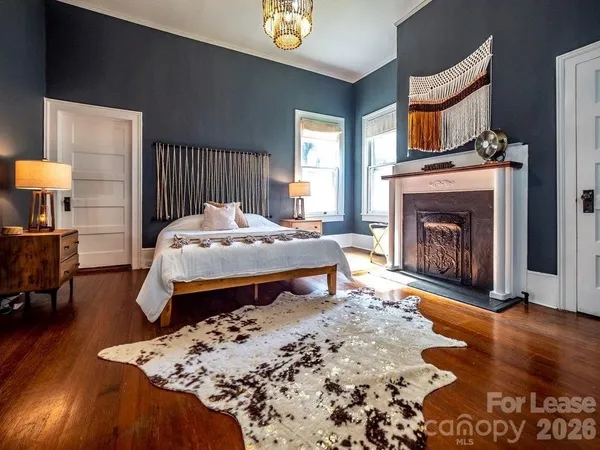 a bedroom with a bed and a fireplace
