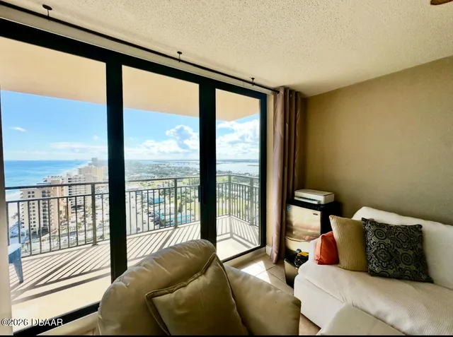 a living room with furniture and a floor to ceiling window