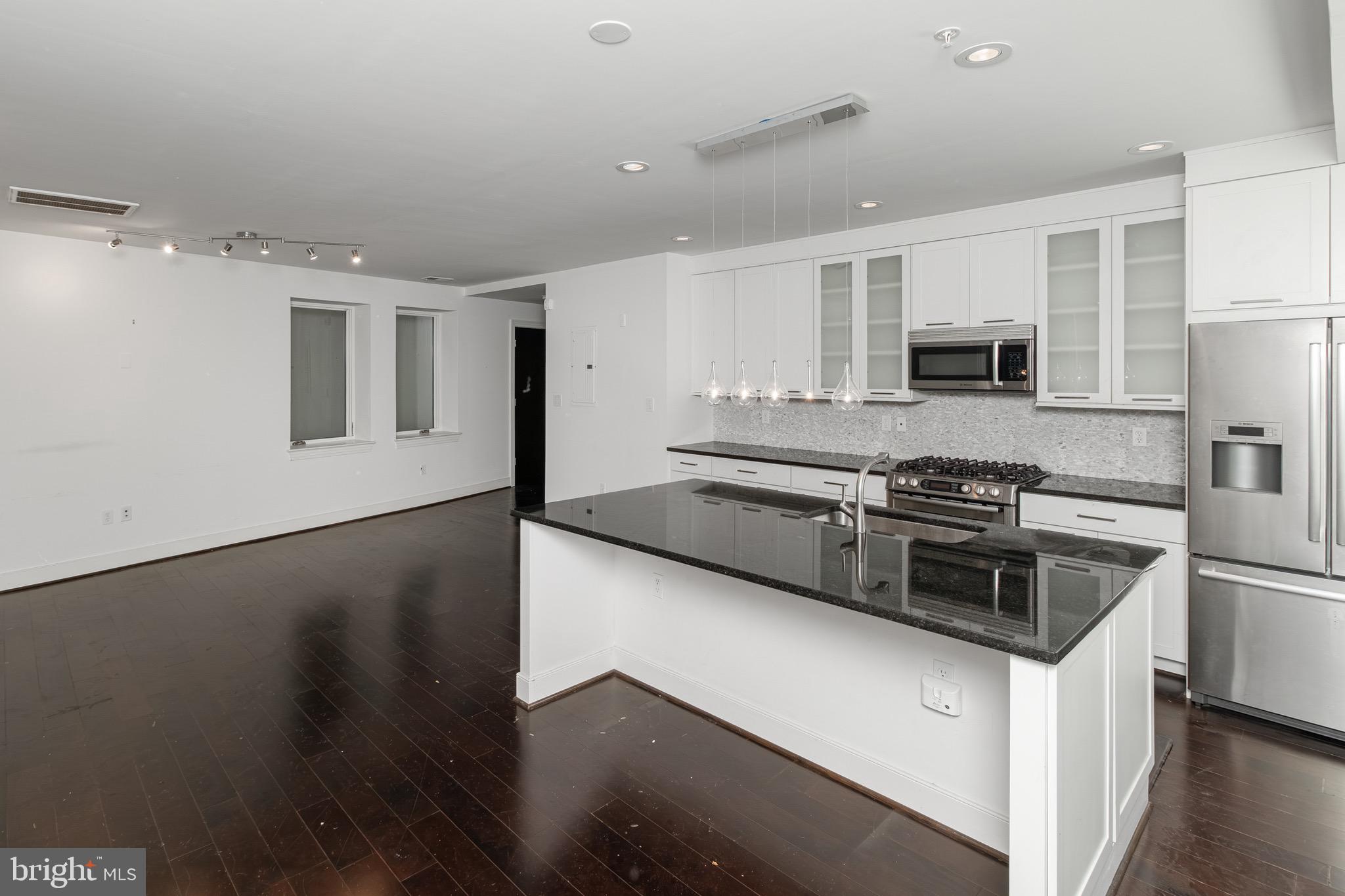 2360 Champlain Street Northwest, Unit B2 Washington, DC 20009 - Photo 2 of 10 a kitchen with stainless steel appliances a stove sink and microwave