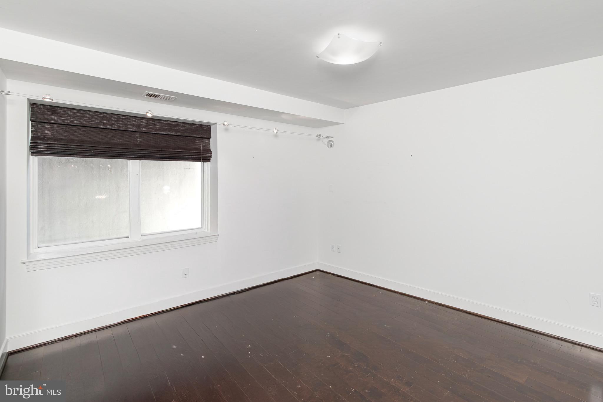 2360 Champlain Street Northwest, Unit B2 Washington, DC 20009 - Photo 5 of 10 an empty room with a window