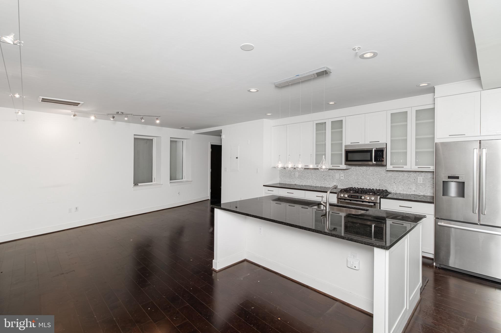 2360 Champlain Street Northwest, Unit B2 Washington, DC 20009 - Photo 9 of 10 a kitchen with stainless steel appliances granite countertop a stove a sink and a refrigerator